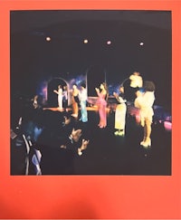 a polaroid photo of a group of people on stage