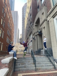 a group of people on a skateboard in a city