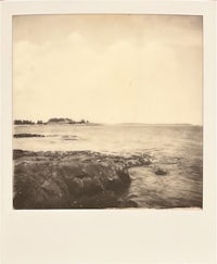 a black and white photograph of a rocky shore