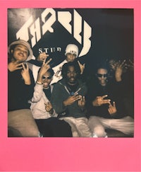 a group of people posing for a photo in a pink polaroid