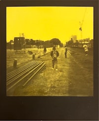 a polaroid photo of a man walking down a street