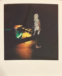 polaroid of a man in a mask on a skateboard