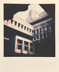 a polaroid photo of a building with a building in the background