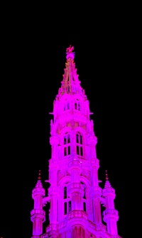 a clock tower with a pink light on it